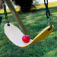 A red apple placed on a yellow swing set against a grassy background. Picked in Nystrom Orchard in Worthington Minnesota.