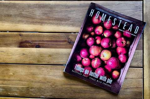 Cover of homestead magazine with apples on a wooden surface. Featuring Nystrom Orchard in Worthington Minnesota.